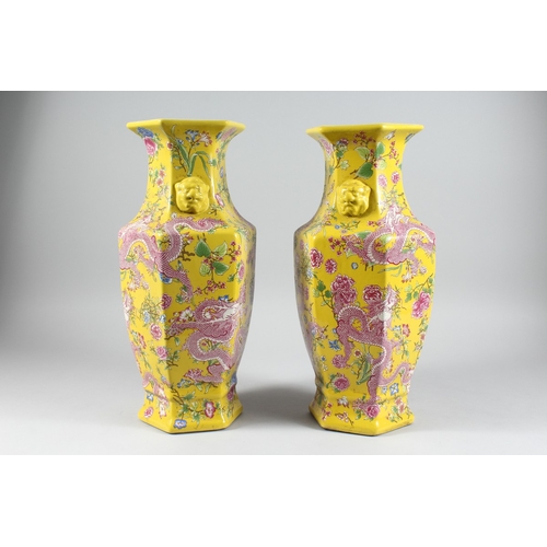 149 - A PAIR OF YELLOW DRAGON DESIGN OCTAGONAL VASES 17 ins high.