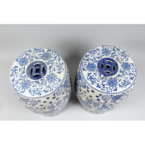 152 - A PAIR OF CHINESE BLUE AND WHITE BARREL SEATS with scrolls, 17 ins high