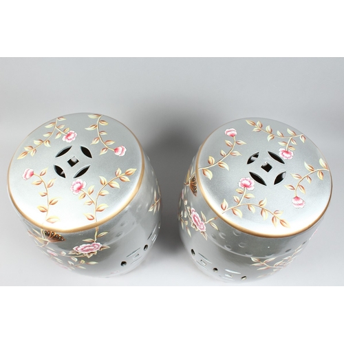 154 - A PAIR OF CHINESE SILVER BARREL SEATS with peonies 17 ins high