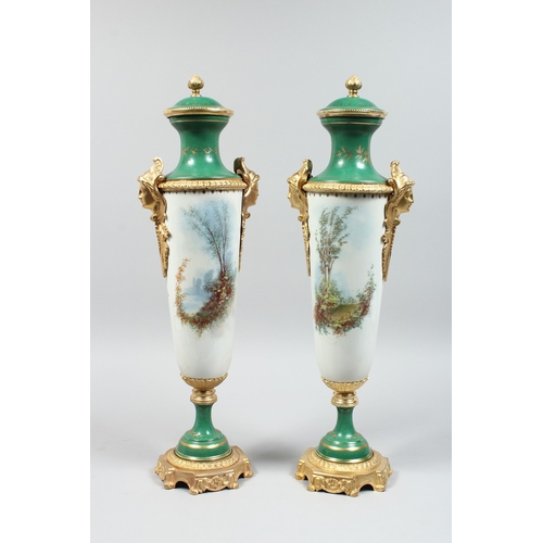 155 - A GOOD PAIR OF SEVRES DESIGN TWO HANDLED VASE AND COVER painted with cupids, 27 ins high.