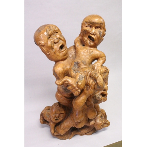 161 - A LARGE UNUSUAL CHINESE ROOTWOOD SCULPTURE OF A MOTHER, FATHER AND THREE CHILDREN, all with anxious ... 