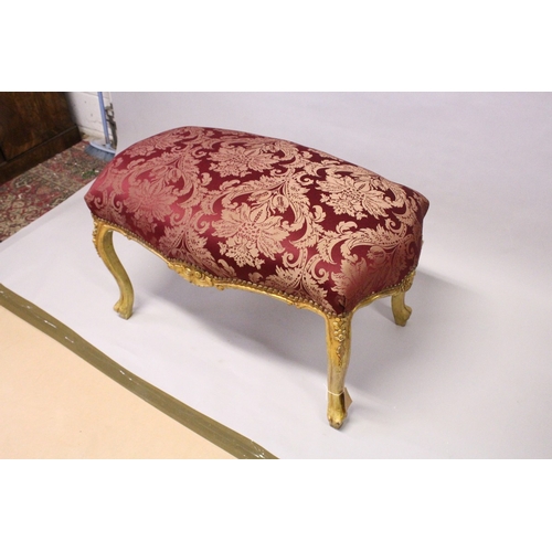 163 - A GILT WOOD LARGE STOOL, with upholstered crimson, classical style fabric, on cabriole legs. 3 ft 4i... 