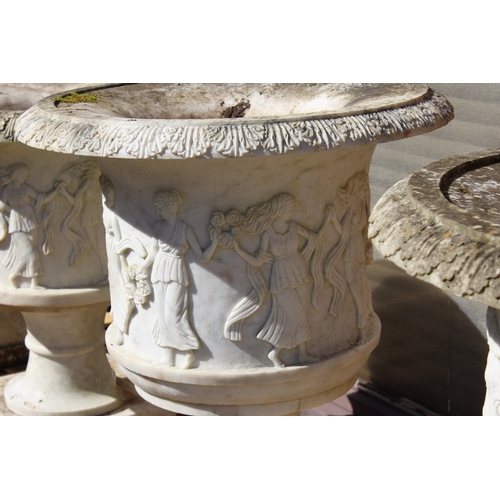 179 - A SUPERB NEAR PAIR OF ITALIAN CARVED WHITE MARBLE URNS ON STANDS, the sides covered with dancing lad... 