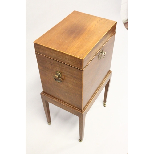 201 - AN EDWARDIAN MAGHOGANY CELLARETTE, with rising top, compartmented interior on a stand with tapering ... 