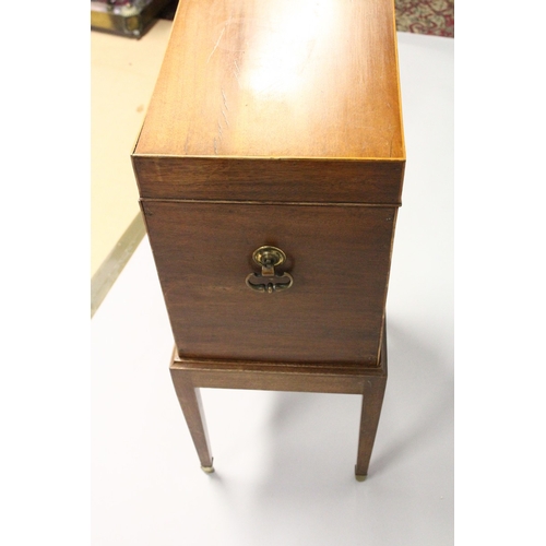 201 - AN EDWARDIAN MAGHOGANY CELLARETTE, with rising top, compartmented interior on a stand with tapering ... 