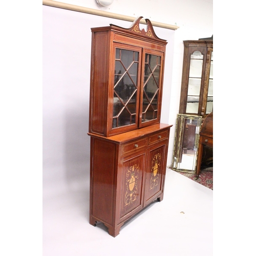 207 - AN EDWARDIAN MAHOGANY STANDING BOOKCASE, the top with swan neck pediment, pair of glazed doors over ... 