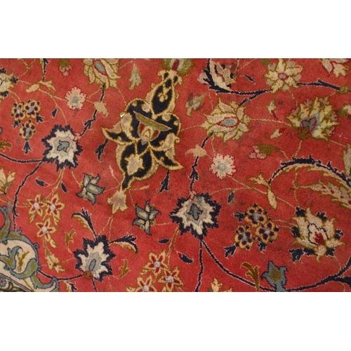 225 - A GOOD SMALL PERSIAN CARPET, red ground with all over floral decoration within a similar blue border... 