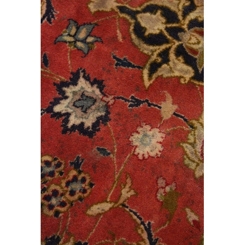 225 - A GOOD SMALL PERSIAN CARPET, red ground with all over floral decoration within a similar blue border... 