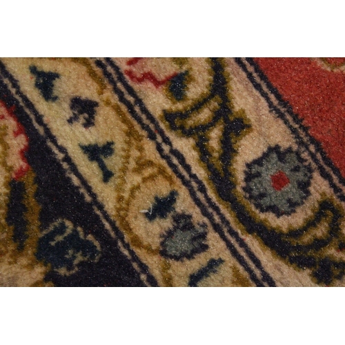 225 - A GOOD SMALL PERSIAN CARPET, red ground with all over floral decoration within a similar blue border... 