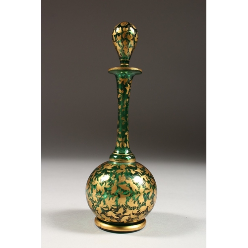 239 - A BOHEMIAN GREEN AND GILT SCENT BOTTLE AND STOPPER. 7 ins high.