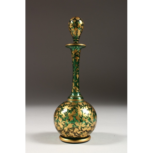 239 - A BOHEMIAN GREEN AND GILT SCENT BOTTLE AND STOPPER. 7 ins high.