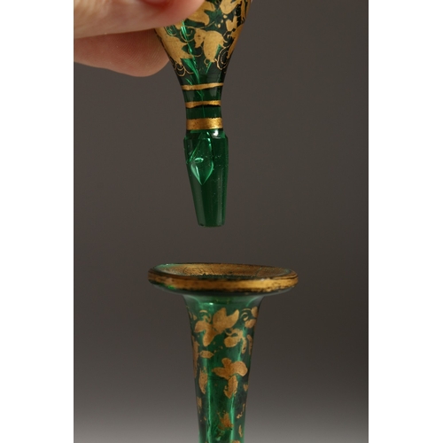 239 - A BOHEMIAN GREEN AND GILT SCENT BOTTLE AND STOPPER. 7 ins high.