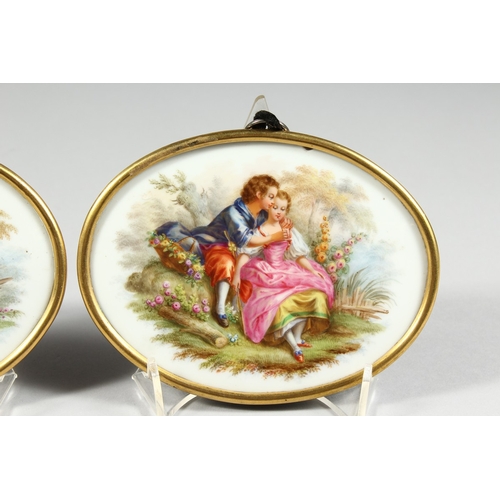 260 - A GOOD  PAIR OF 19TH CENTURY CONTINENTAL PORCELAIN OVALS of young lovers in a gilt metal frame, 4 in... 