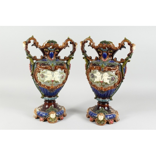 262 - A GOOD PAIR OF CONTINENTAL POTTERY MAJOLICA DESIGN TWO HANDLED VASES, blue ground, green banding wit... 