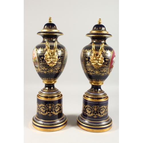 276 - A SUPERB PAIR OF VIENNA VASES, COVERS AND STANDS, the rich blue ground edged in gilt and painted wit... 