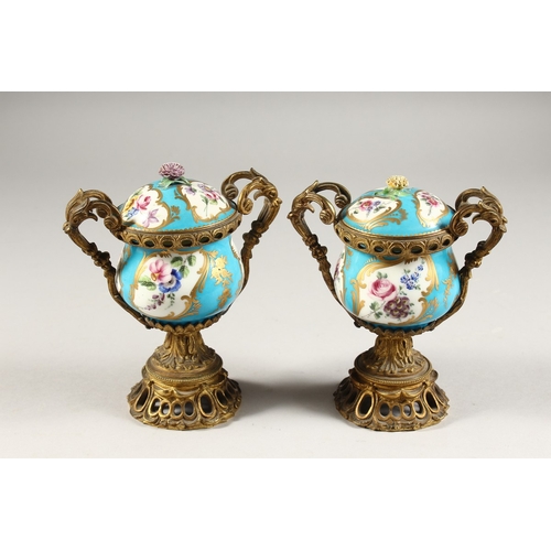 281 - A GOOD PAIR OF 19TH CENTURY SEVRES PORCELAIN AND ORMOLU TWO-HANDLED VASES AND COVERS, blue ground en... 