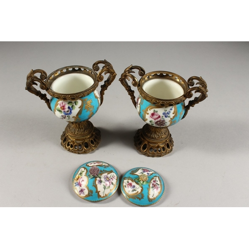 281 - A GOOD PAIR OF 19TH CENTURY SEVRES PORCELAIN AND ORMOLU TWO-HANDLED VASES AND COVERS, blue ground en... 