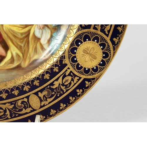 289 - A GOOD VIENNA CIRCULAR PLATE, blue and gilt border, the centre painted with a classical scene pourin... 