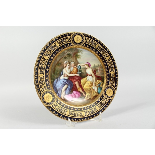 289 - A GOOD VIENNA CIRCULAR PLATE, blue and gilt border, the centre painted with a classical scene pourin... 