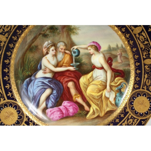 289 - A GOOD VIENNA CIRCULAR PLATE, blue and gilt border, the centre painted with a classical scene pourin... 