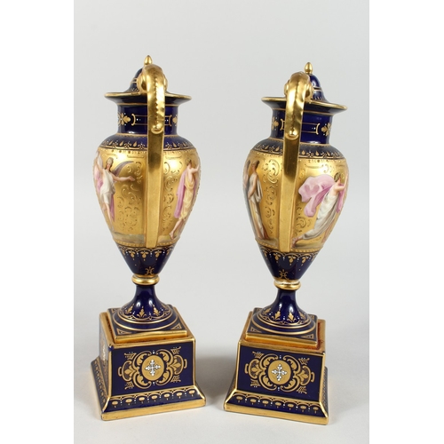 294 - A SUPERB PAIR OF VIENNA TWO HANDLED VASES AND COVERS, rich blue and gilt grounds, painted with a ban... 