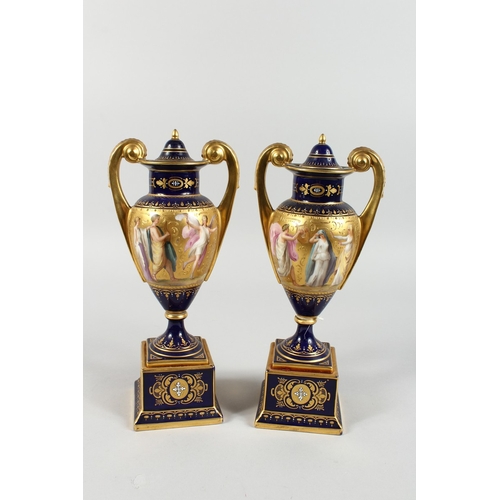 294 - A SUPERB PAIR OF VIENNA TWO HANDLED VASES AND COVERS, rich blue and gilt grounds, painted with a ban... 