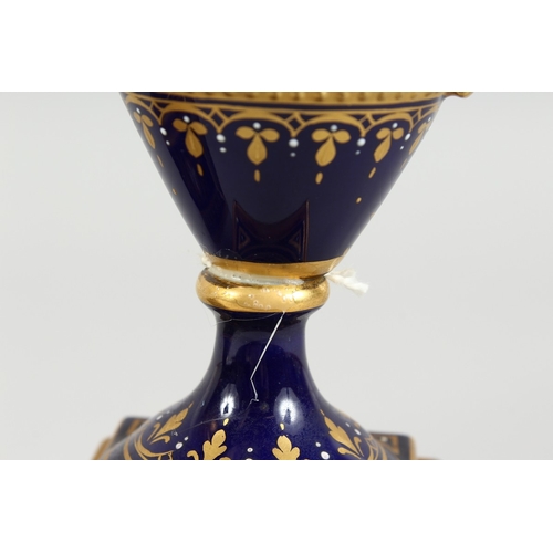 294 - A SUPERB PAIR OF VIENNA TWO HANDLED VASES AND COVERS, rich blue and gilt grounds, painted with a ban... 