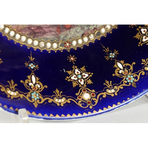 299 - AN 18TH CENTURY SEVRES PORCELAIN CIRCULAR DEEP DISH rich blue ground, pearl work, the  centre painte... 