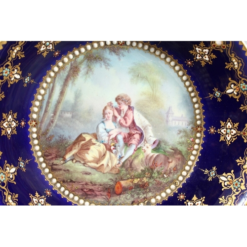 299 - AN 18TH CENTURY SEVRES PORCELAIN CIRCULAR DEEP DISH rich blue ground, pearl work, the  centre painte... 