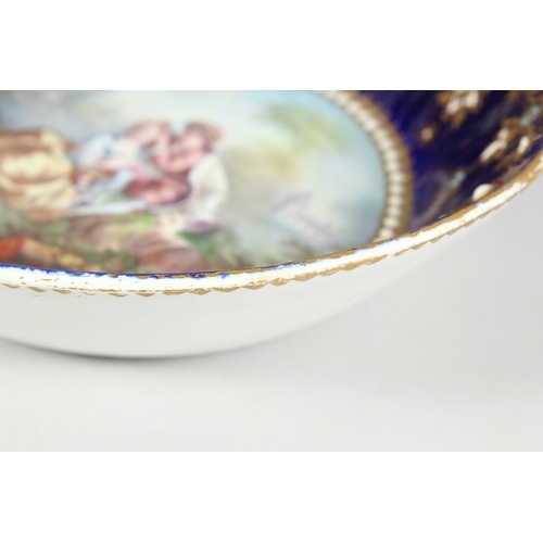 299 - AN 18TH CENTURY SEVRES PORCELAIN CIRCULAR DEEP DISH rich blue ground, pearl work, the  centre painte... 