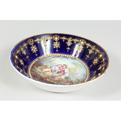 299 - AN 18TH CENTURY SEVRES PORCELAIN CIRCULAR DEEP DISH rich blue ground, pearl work, the  centre painte... 