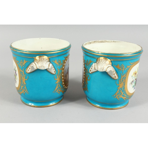 303 - A GOOD PAIR OF SEVRES BLUE GROUND CACHE POTS 4.5 ins high with scroll handles and painted with rever... 