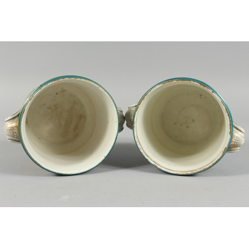 303 - A GOOD PAIR OF SEVRES BLUE GROUND CACHE POTS 4.5 ins high with scroll handles and painted with rever... 