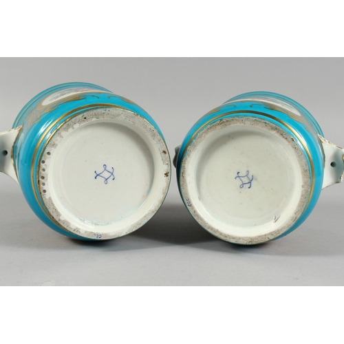 303 - A GOOD PAIR OF SEVRES BLUE GROUND CACHE POTS 4.5 ins high with scroll handles and painted with rever... 