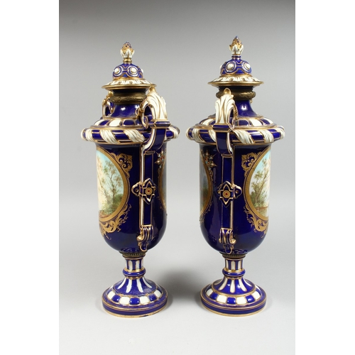 307 - A SUPERB LARGE PAIR OF SEVRES TWO HANDLED VASES AND COVERS, rich blue and white ground edged in gilt... 