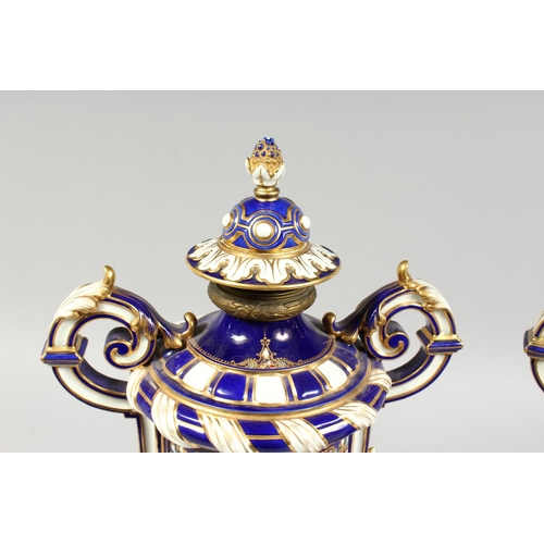 307 - A SUPERB LARGE PAIR OF SEVRES TWO HANDLED VASES AND COVERS, rich blue and white ground edged in gilt... 