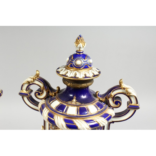 307 - A SUPERB LARGE PAIR OF SEVRES TWO HANDLED VASES AND COVERS, rich blue and white ground edged in gilt... 