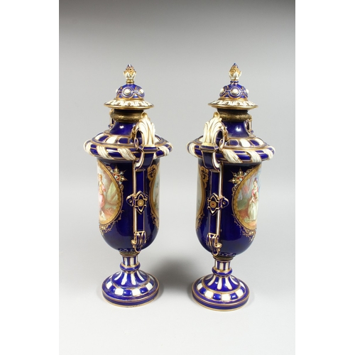 307 - A SUPERB LARGE PAIR OF SEVRES TWO HANDLED VASES AND COVERS, rich blue and white ground edged in gilt... 