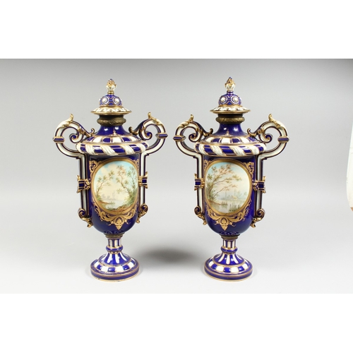 307 - A SUPERB LARGE PAIR OF SEVRES TWO HANDLED VASES AND COVERS, rich blue and white ground edged in gilt... 