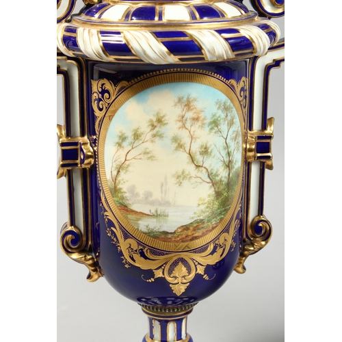 307 - A SUPERB LARGE PAIR OF SEVRES TWO HANDLED VASES AND COVERS, rich blue and white ground edged in gilt... 