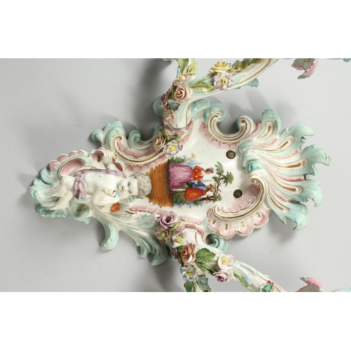 308 - A GOOD PAIR OF MEISSEN PORCELAIN TWO LIGHT WALL SCONCES with cupid and encrusted with flowers and pa... 