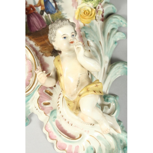 308 - A GOOD PAIR OF MEISSEN PORCELAIN TWO LIGHT WALL SCONCES with cupid and encrusted with flowers and pa... 