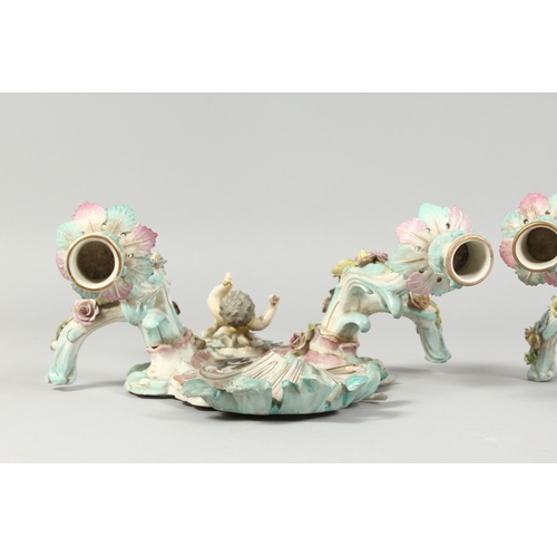 308 - A GOOD PAIR OF MEISSEN PORCELAIN TWO LIGHT WALL SCONCES with cupid and encrusted with flowers and pa... 