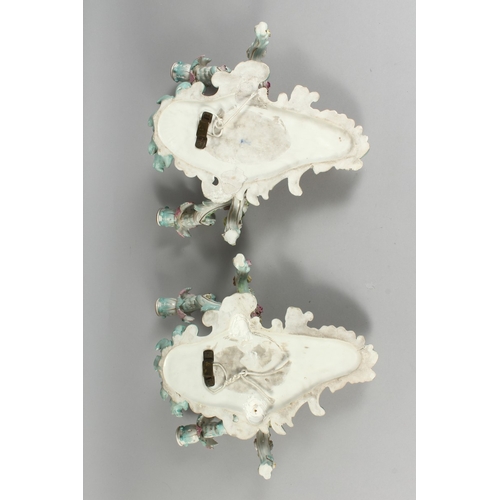 308 - A GOOD PAIR OF MEISSEN PORCELAIN TWO LIGHT WALL SCONCES with cupid and encrusted with flowers and pa... 