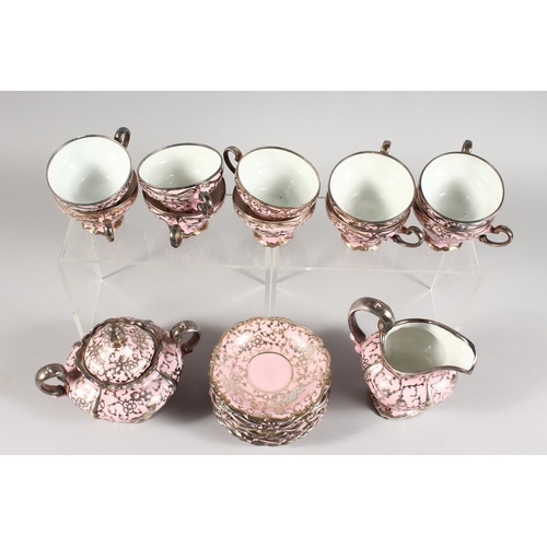 315 - A ROSENTHAL SILVER OVERLAID PINK PORCELAIN TEA SET comprising ten cups and saucers, sugar basin and ... 