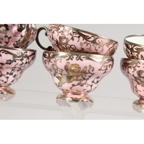 315 - A ROSENTHAL SILVER OVERLAID PINK PORCELAIN TEA SET comprising ten cups and saucers, sugar basin and ... 