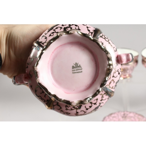 315 - A ROSENTHAL SILVER OVERLAID PINK PORCELAIN TEA SET comprising ten cups and saucers, sugar basin and ... 