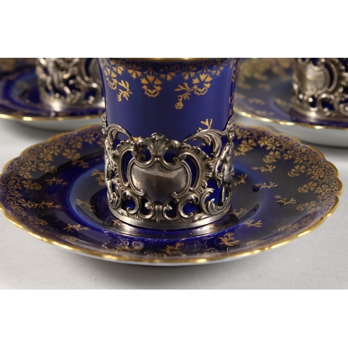 318 - A  SET OF FIVE ROYAL VIENNA BLUE AND GILT CUPS AND SIX SAUCERS with silver handles