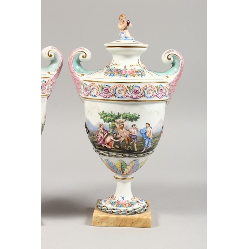 325 - A GOOD PAIR OF CAPODIMONTE URN SHAPED, TWO HANDLED VASES AND COVERS  with classical figures in relie... 