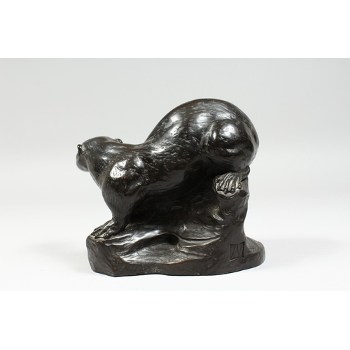 341 - A BRONZED FIGURE OF A OTTER on a rocky base,signed T Wick.